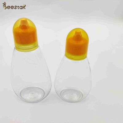 購入 蜂蜜の貯蔵のための250ml 350ml 500mlの蜂蜜の瓶そしてスプーンのプラスチック空の蜂蜜のびん オンライン製造