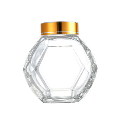 購入 200ML 380MLの金銀製の赤く黒い金属のふたが付いているガラス六角形の蜂蜜のびん オンライン製造